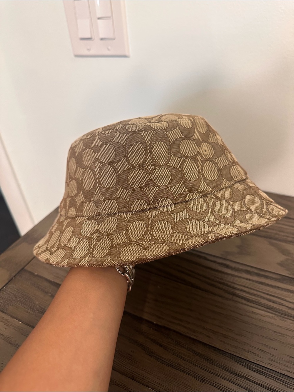Coach womenโs Signature Bucket Hat in Beige and Tan